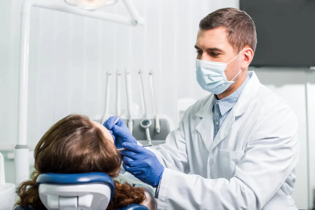 Dentist examining patient in dental chair dentist in Winter Park
