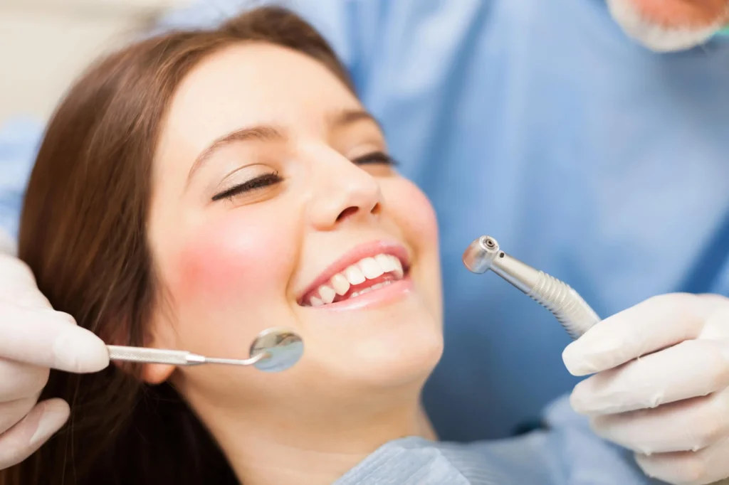 Smiling woman during dental checkup, dentist in Edison
